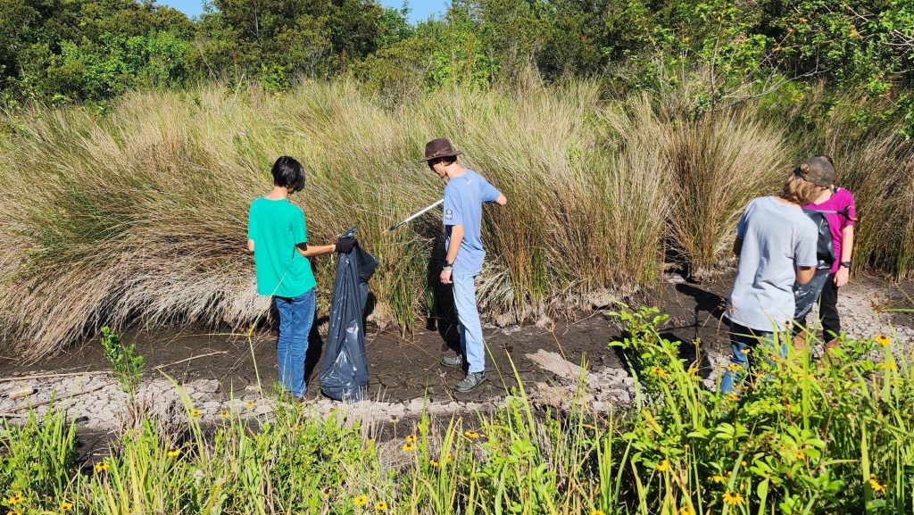 Volunteers cleaning up debris from property