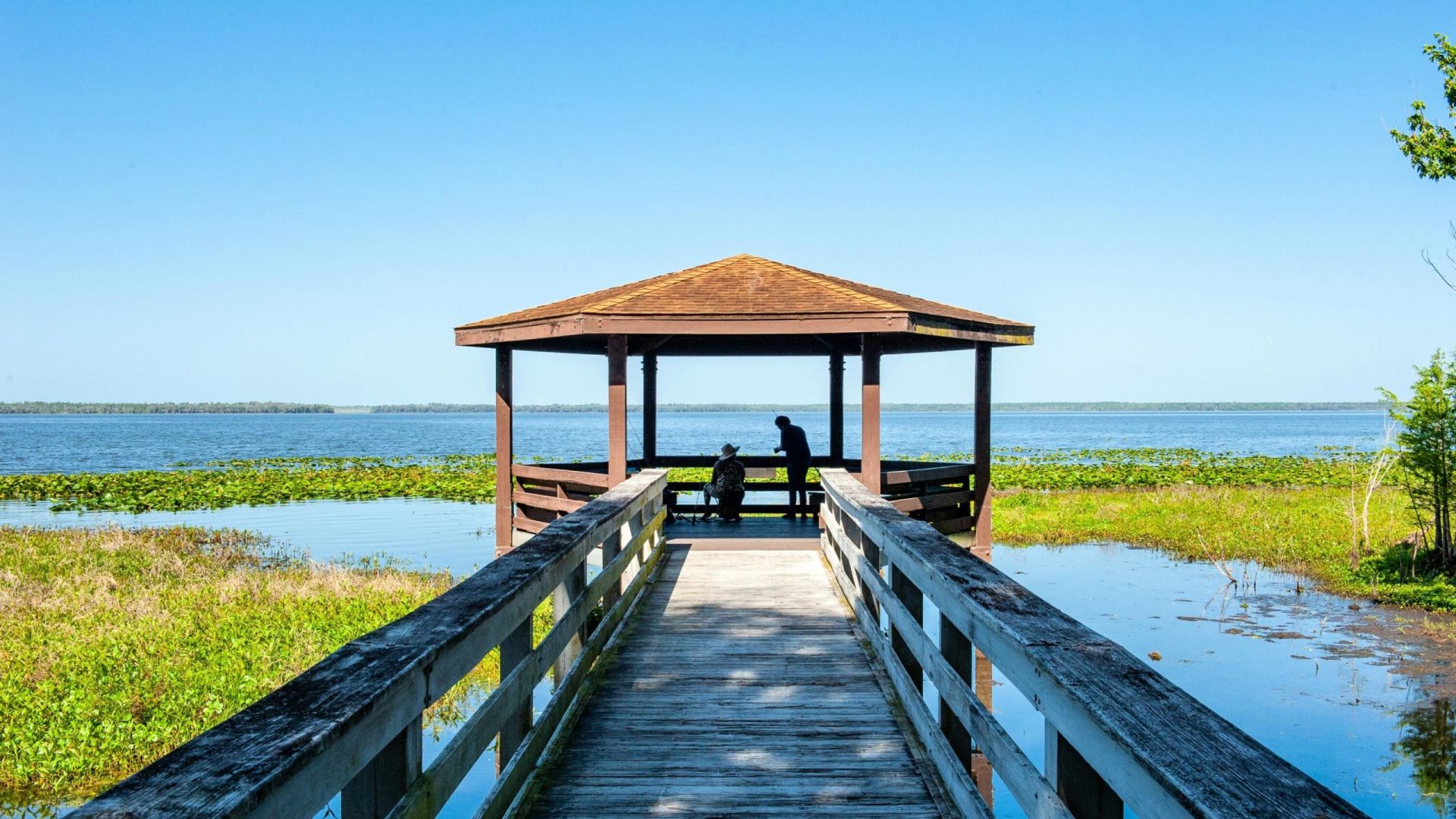 20170328 Photo of two people fishing from a covered dock