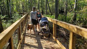 a couple walking down a boardwalk