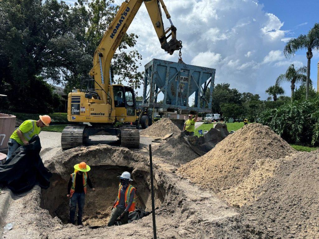 Work crew inspecting septic conversion project.