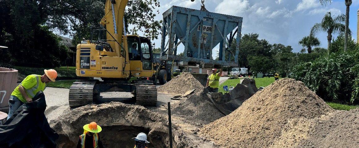 Work crew inspecting septic conversion project.
