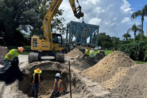 Work crew inspecting septic conversion project.