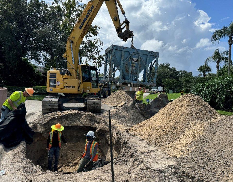 Work crew inspecting septic conversion project.