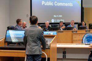 Board members listening to comments from student