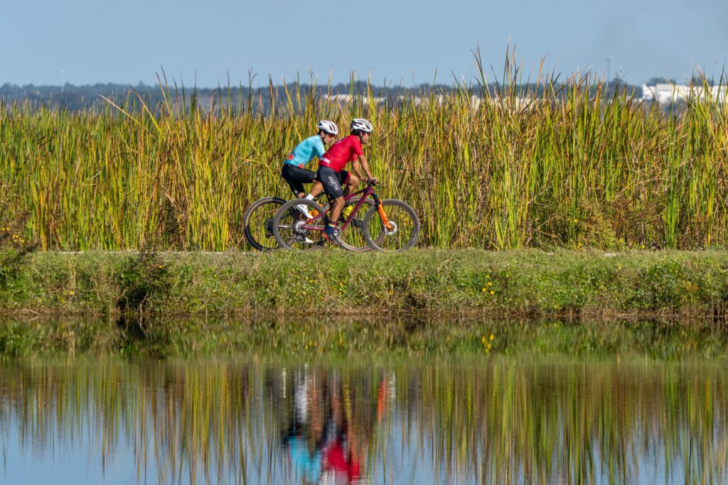 The St. Johns River Water Management District has even more reason to celebrate Florida Biking Month: the long-anticipated trail around Lake Apopka is now fully connected. 

One of the District’s most popular off-road biking destinations, the Lake Apopka Loop Trail follows the lake’s edge through the Lake Apopka North Shore, offering more than 20 miles of hiking and biking opportunities. Spanning both Orange and Lake counties, the journey around was once incomplete, requiring cyclists to ride sections along roadways to finish the ride.