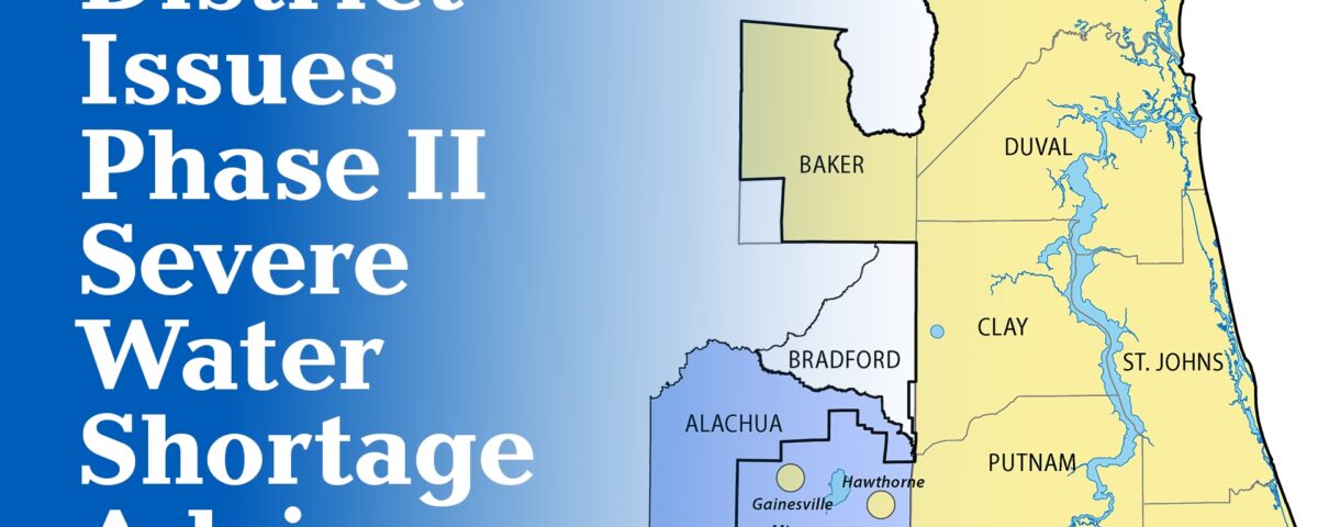 A map graphic announcing a Phase II Severe Water Shortage Advisory issued by the water management district, showing the affected area highlighted in blue covering Alachua and Bradford counties, with cities Gainesville, Micanopy, and Hawthorne marked, surrounded by the yellow-shaded counties of Nassau, Baker, Duval, Clay, St. Johns, Putnam, and Flagler within the district boundary