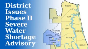 A map graphic announcing a Phase II Severe Water Shortage Advisory issued by the water management district, showing the affected area highlighted in blue covering Alachua and Bradford counties, with cities Gainesville, Micanopy, and Hawthorne marked, surrounded by the yellow-shaded counties of Nassau, Baker, Duval, Clay, St. Johns, Putnam, and Flagler within the district boundary