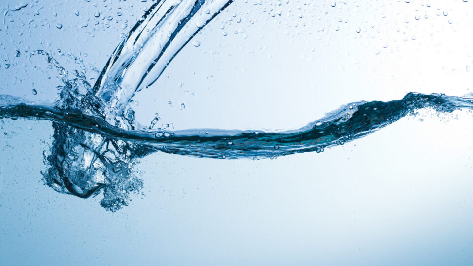 Flowing water, drops, sprays, splashes on a neutral background, studio light, abstraction, minimalism