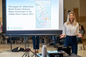 Melissa-IRL-USJR District staff presenting in front of a projector screen