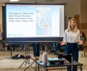 District staff presenting in front of a projector screen