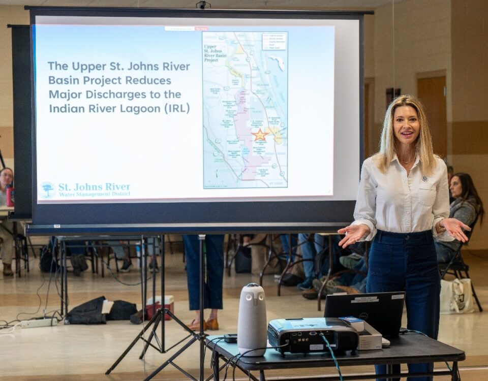 District staff presenting in front of a projector screen