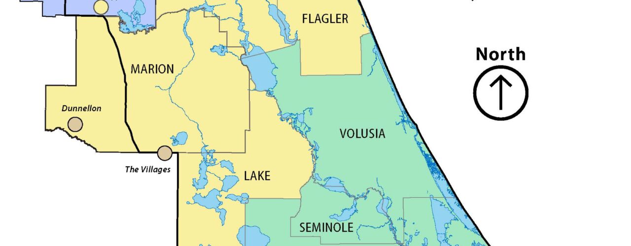 Map of the St. Johns River Water Management District boundary showing water shortage restriction zones by county as of May 11, 2026. Counties in yellow are under Phase III Extreme Water Shortage, including Nassau, Duval, Clay, St. Johns, Putnam, Marion, Flagler, and Lake. Alachua and Bradford counties are shown in blue, indicating continued restrictions from the Suwannee River Water Management District. A small area in southwestern Marion County is shown in tan, indicating continued restrictions from the Southwest Florida Water Management District. Orange and Osceola counties are shown in light purple, indicating continued restrictions from the South Florida Water Management District. Volusia, Seminole, Brevard, Indian River, and coastal portions of other counties are shown in green, indicating follow local or standard restrictions. A north arrow and Florida state inset map are included for reference.