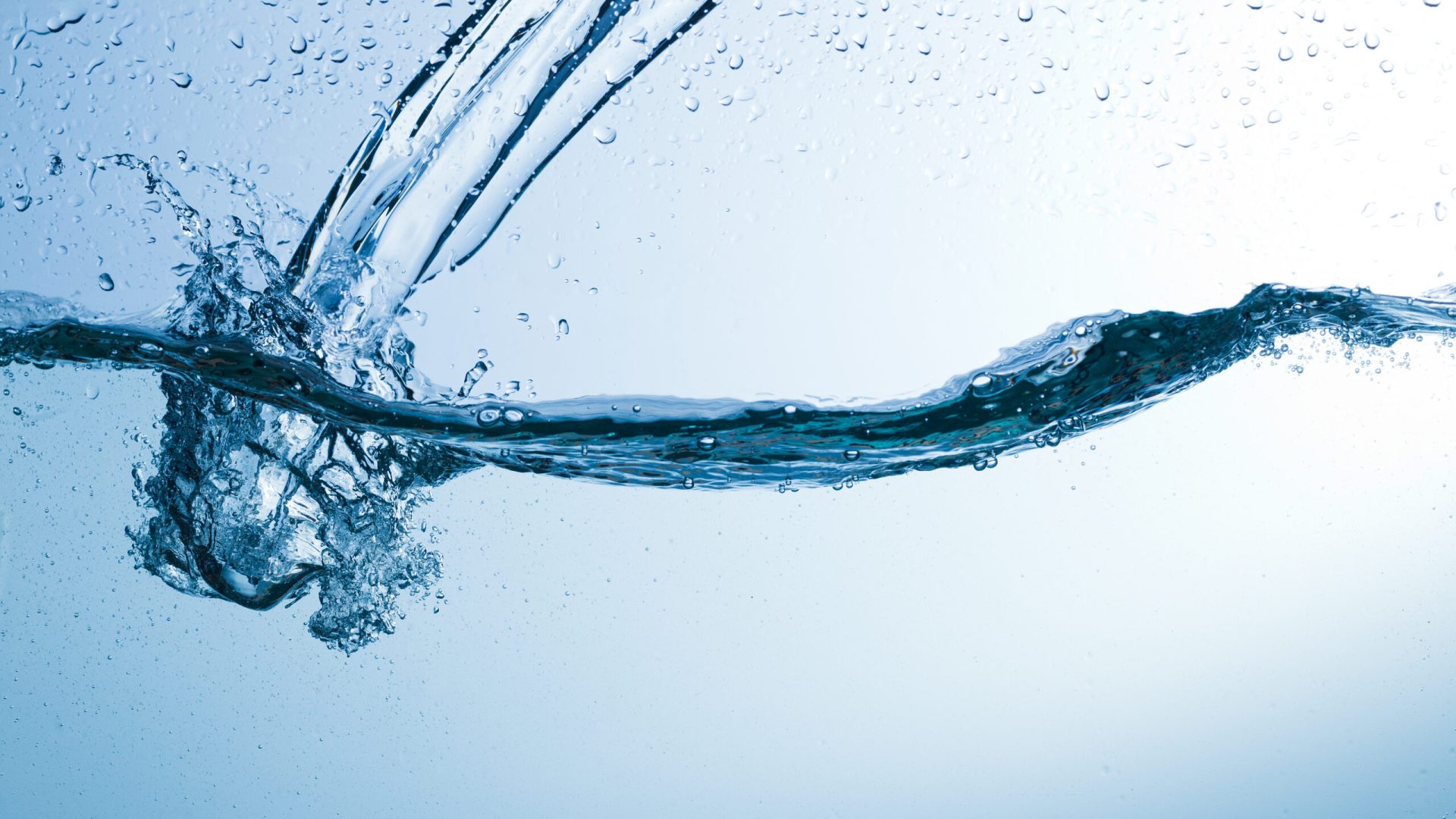 Flowing water, drops, sprays, splashes on a neutral background, studio light, abstraction, minimalism